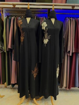 Luxury black Dubai abaya with floral side embroidery and modest flowing design.